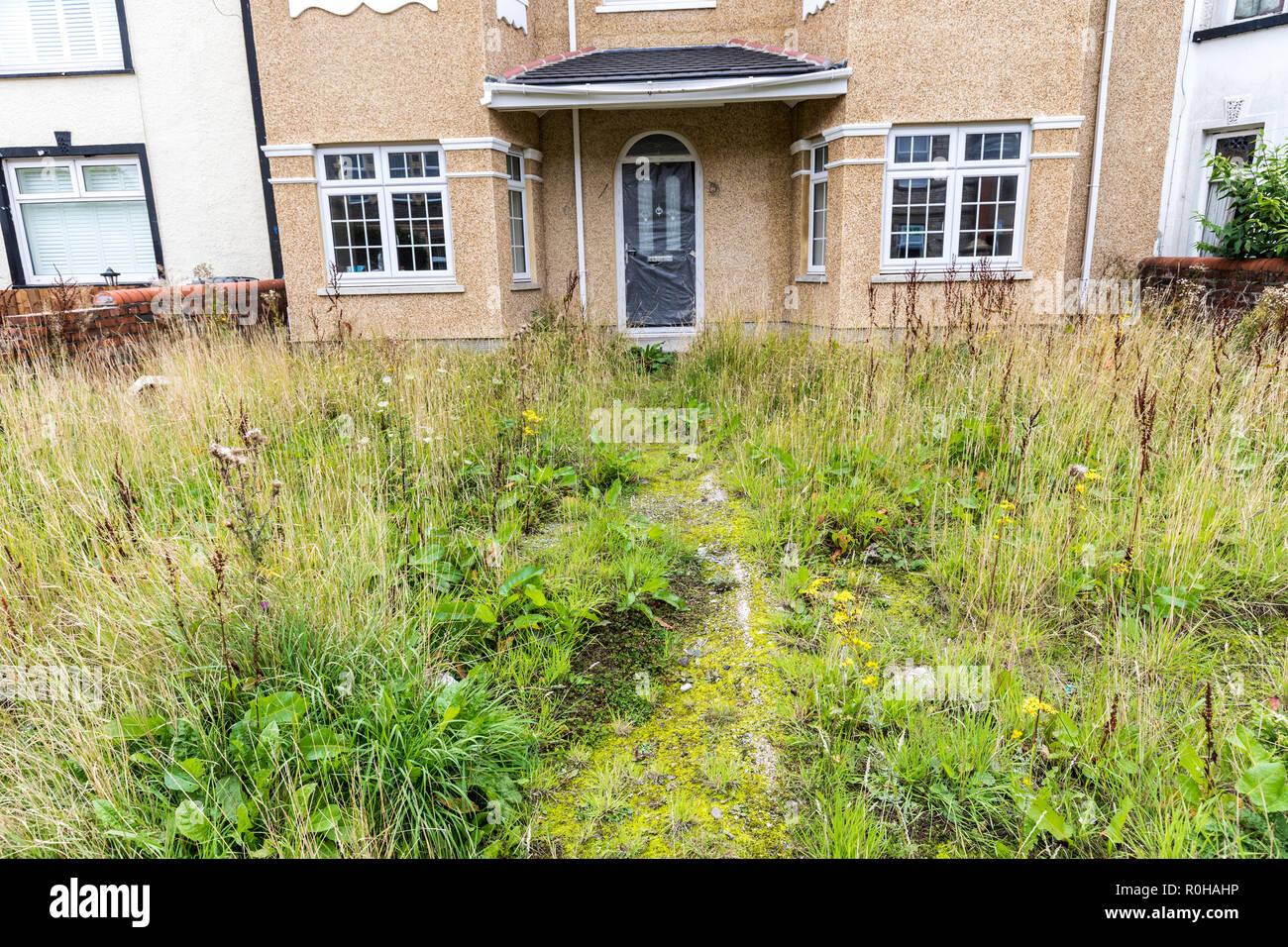 Renovated house with untidy garden, Brynmawr, Wales, UK Stock Photo