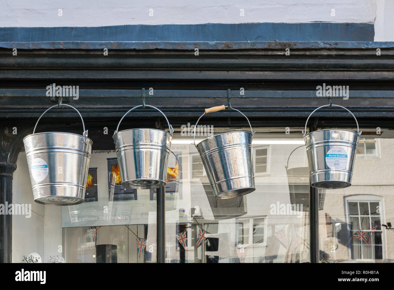 Galvanised metal buckets hanging up outside a traditional hardware store in Ludlow, Shropshire Stock Photo