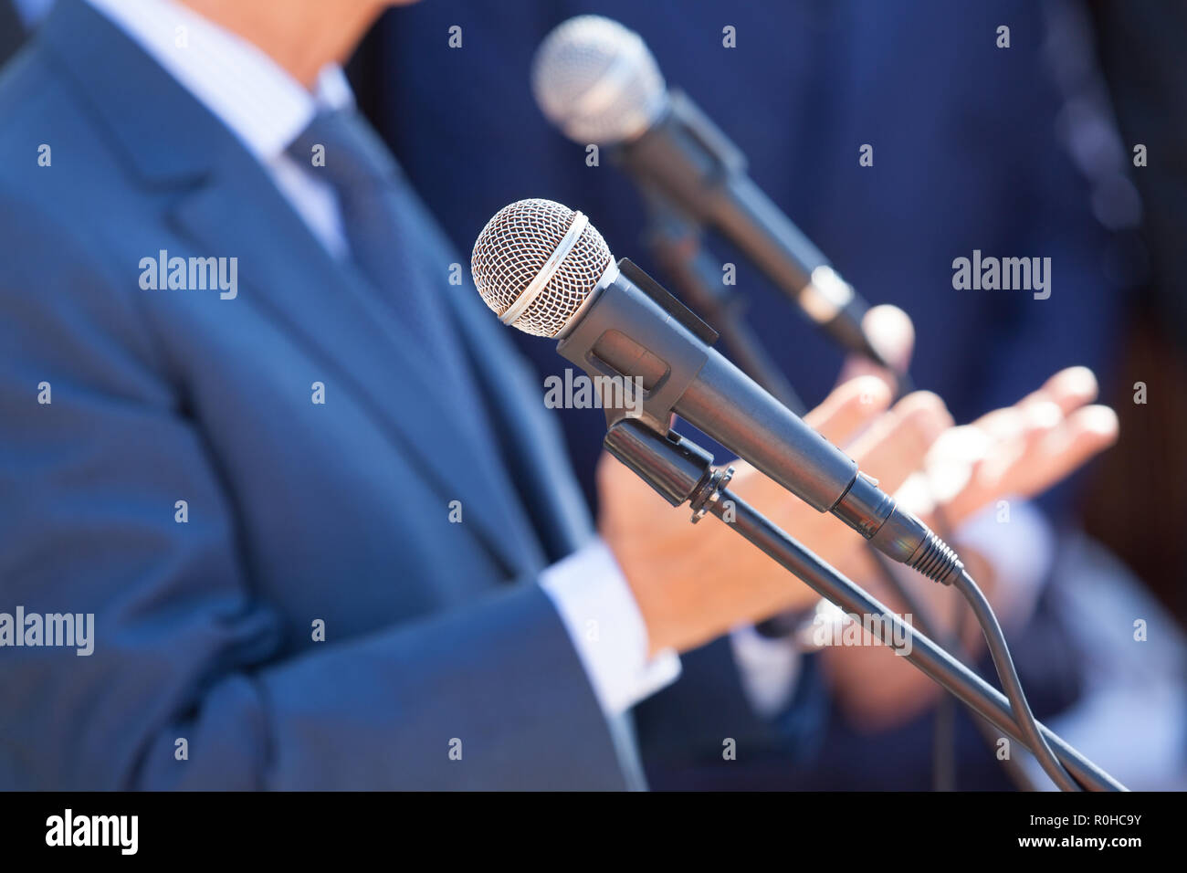 A politician or a business person giving speech at a media event. Public relations in practice. Stock Photo