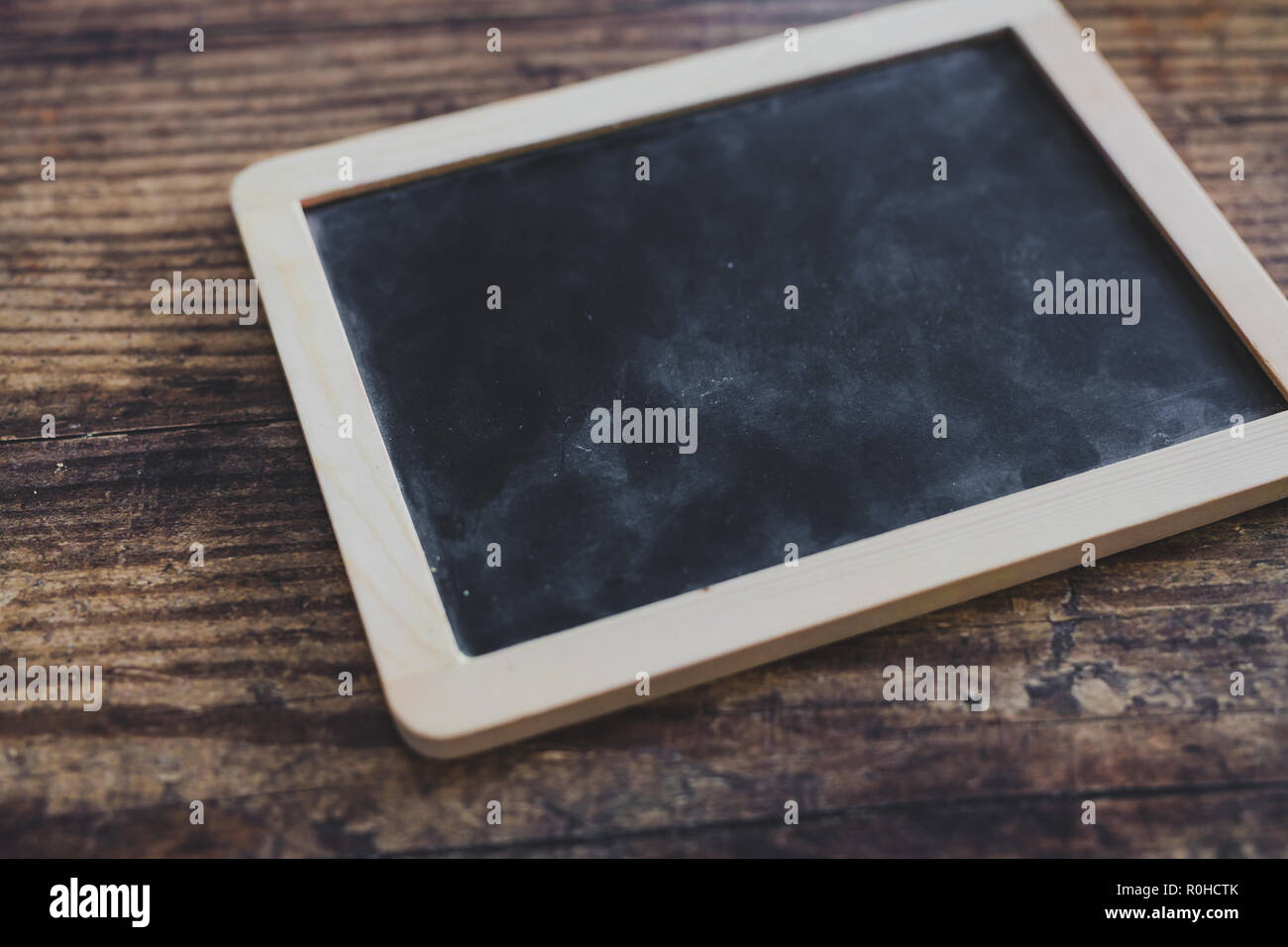 small vintage chalk blackboard on rustic wooden table, concept of
