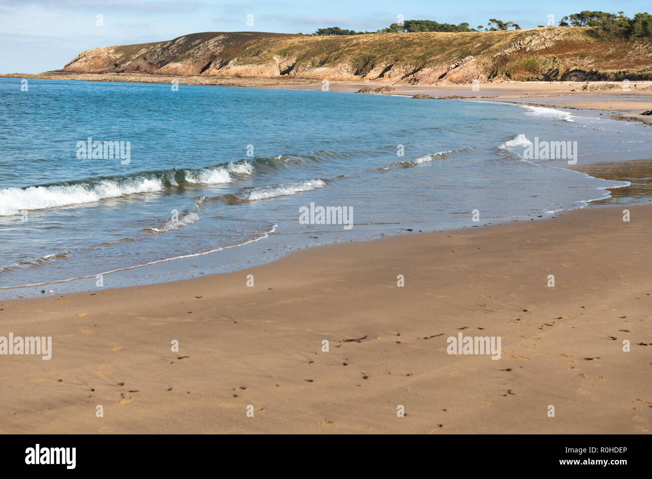 Warm afternoon on empty beach with dunes in Brittany, France. Stock Photo