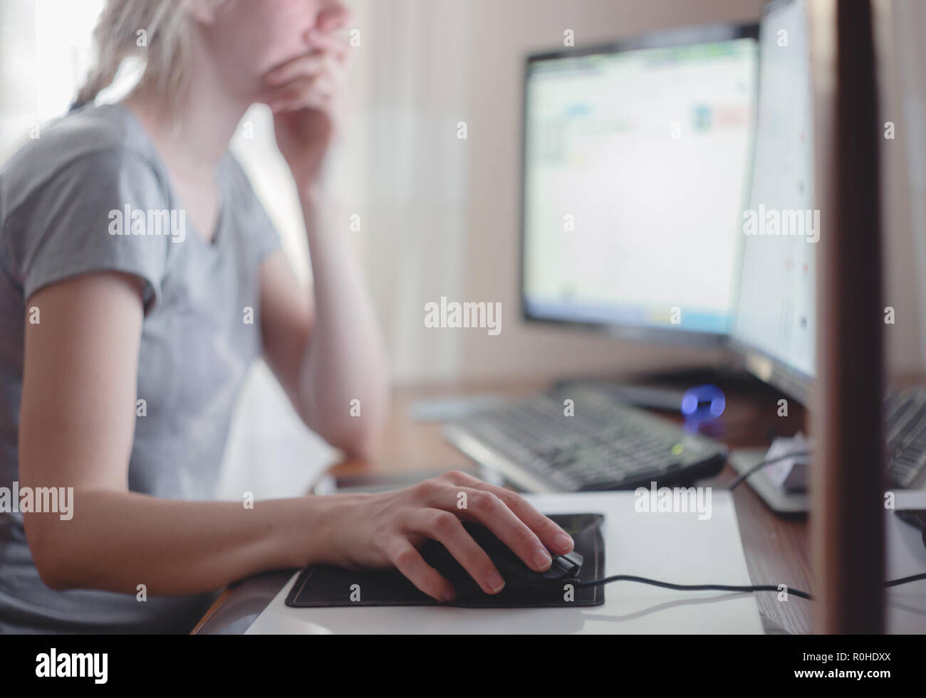 Young woman working with computer at home office. Stock Photo
