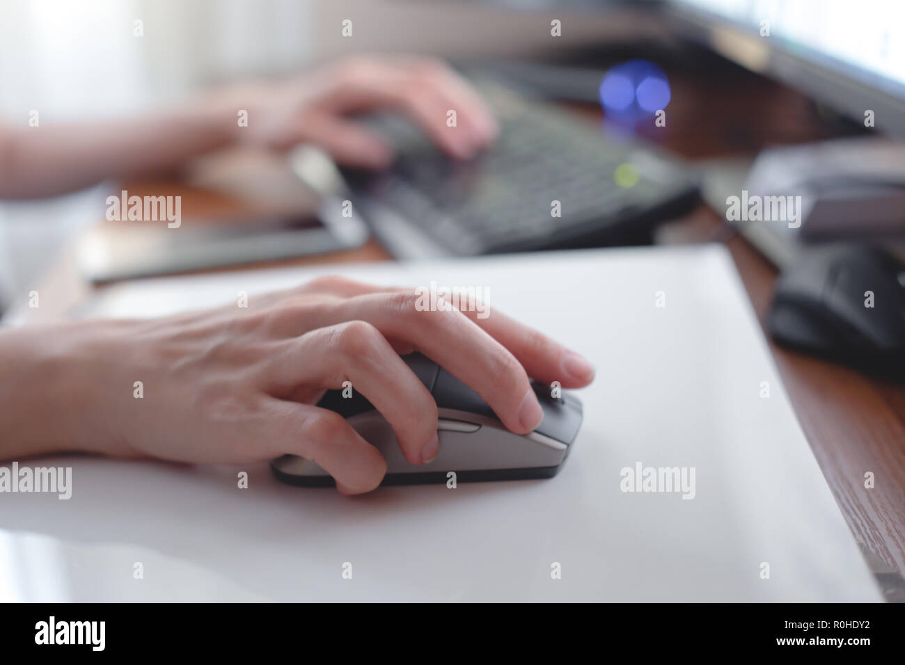 Young woman working with computer at home office. Stock Photo