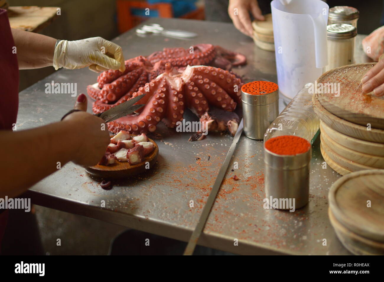 Cooks Chopping Octopus At Becerrea Octopus Fair. Cooking, Food, Travel, Professions, jobs. August 3, 2018. Becerrea, Lugo, Galicia, Spain. Stock Photo