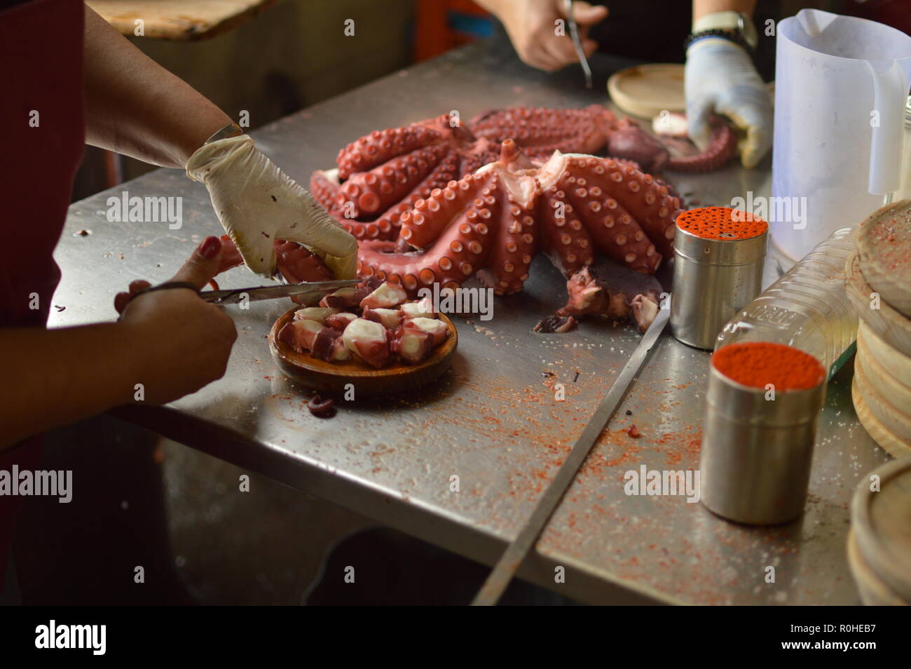 Cooks Chopping Octopus At Becerrea Octopus Fair. Cooking, Food, Travel, Professions, jobs. August 3, 2018. Becerrea, Lugo, Galicia, Spain. Stock Photo