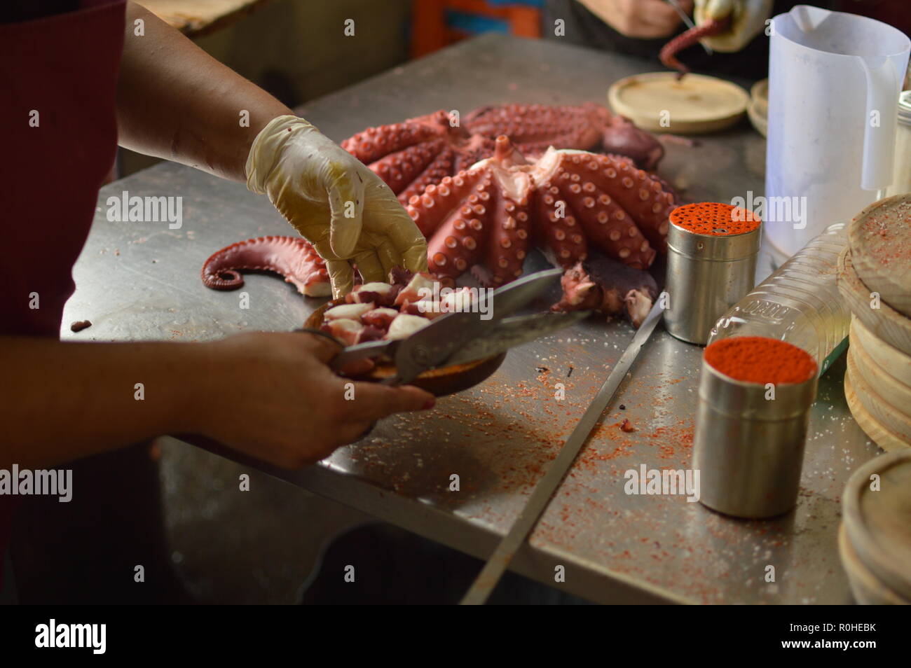 Cooks Chopping Octopus At Becerrea Octopus Fair. Cooking, Food, Travel, Professions. August 3, 2018. Becerrea, Lugo, Galicia, Spain. Stock Photo