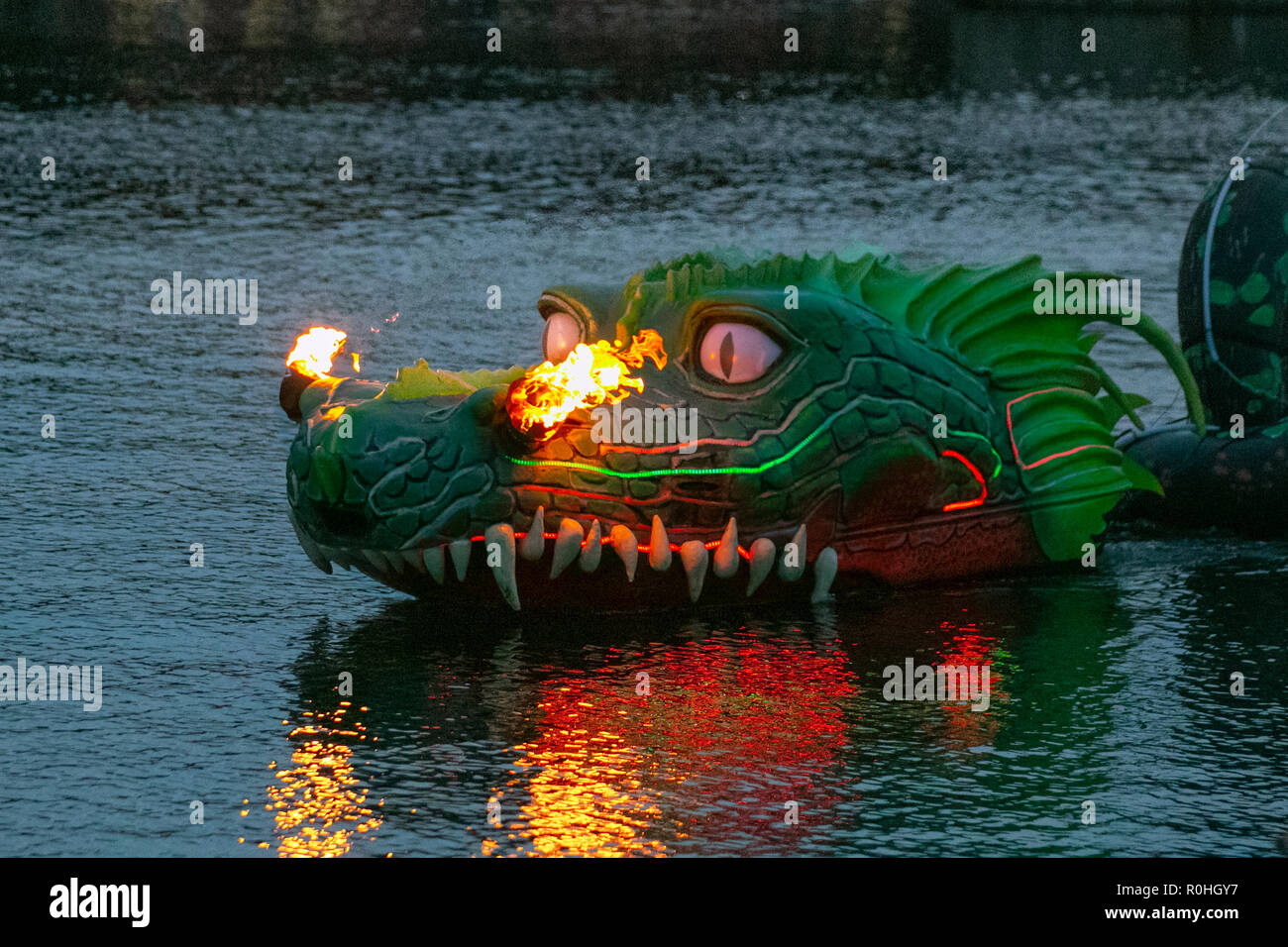 Green fire-breathing dragon at Royal Albert Dock Liverpool, UK. 4th Nov 2018. The Wave, River of Light installation on Bonfire Night 2018. Tens of thousands of people lined on both sides of the Mersey for the free spectacle to see Merseyside’s waterfront lit up with a firework display and specially commissioned light installations including streets performances on the waterfront including fire breathing floating dragons, animal, art, fantasy, isolated, flame, monster, colorful, drawing, head, mythology, aggressive, hot, motion, power, scale, exotic, pet animal. Stock Photo