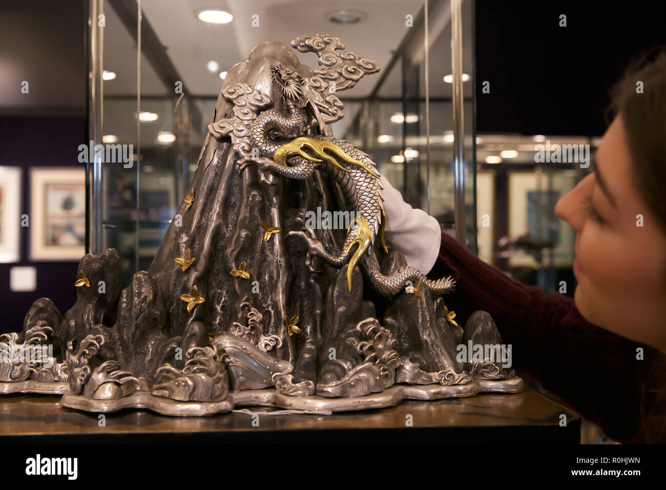 London, UK. 5th Nov, 2018. Asian Art Week photocall takes place at Bonhams New Bond Street, London. On display: Detail of rare silver, gilt and copper okimono of a dragon ascending Mount Fuji, Estimate £30,000-50,000. The preview is for Bonhams Fine Japanese, Fine Chinese and The Ollivier Collection of Early Chinese Art: A Journey Through Time sales which take place on the 8th November 2018. Credit: Keith Larby/Alamy Live News Stock Photo