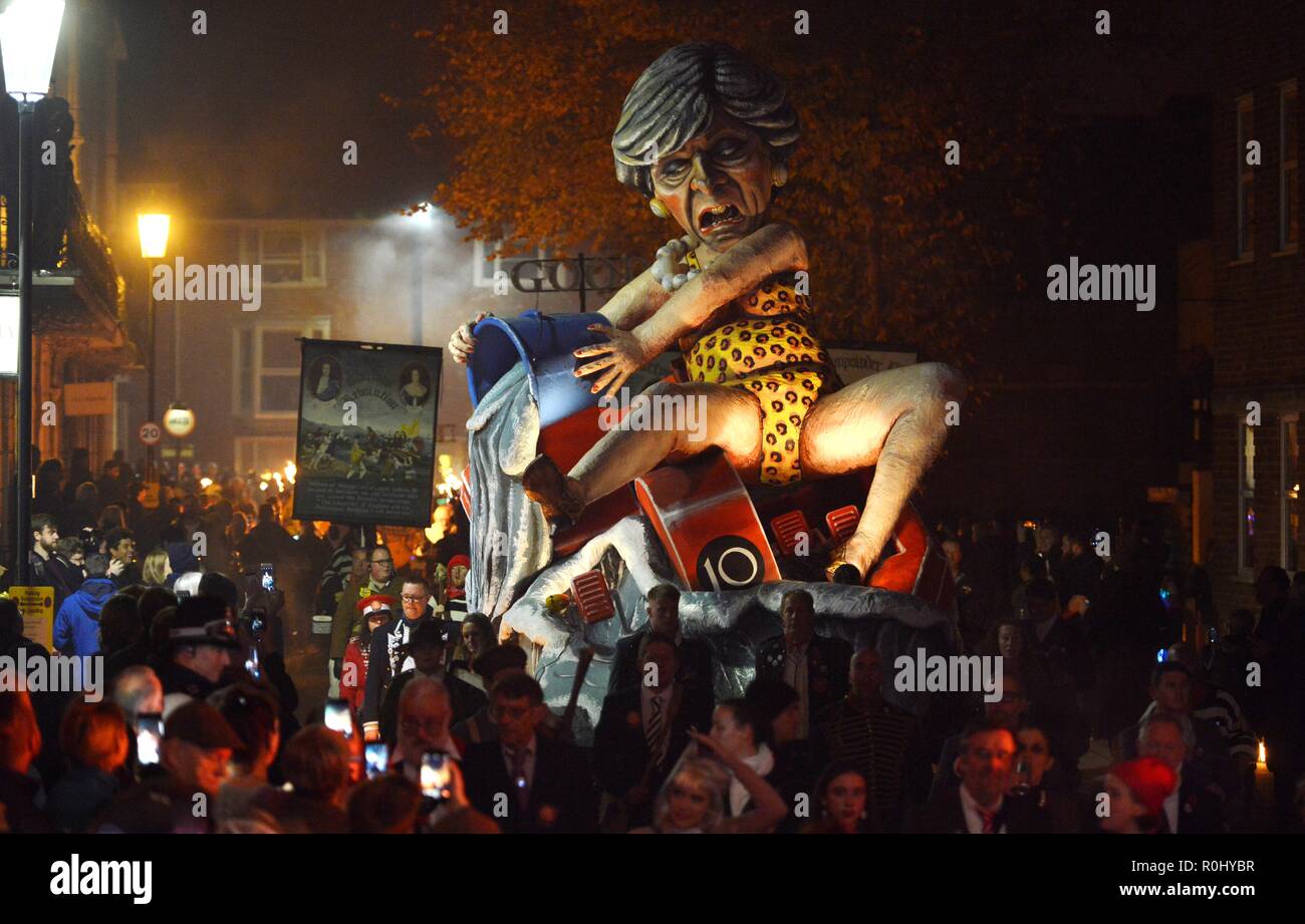 Lewes, East Sussex, UK. 5th November 2018. Theresa May effigy pulled through the streets of Lewes, East Sussex during the towns famous Bonfire celebrations. The effigy, created by Cliffe Bonfire Society, appears to show Theresa May bailing out a sinking paddle boat with a number 10 on the front. ©️Peter Cripps/Alamy Live News Stock Photo