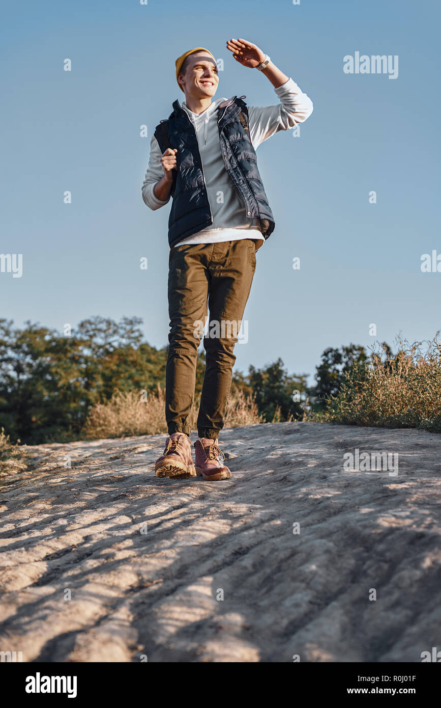 Young tourist blogger what walks at mountains. Bottom view Stock Photo