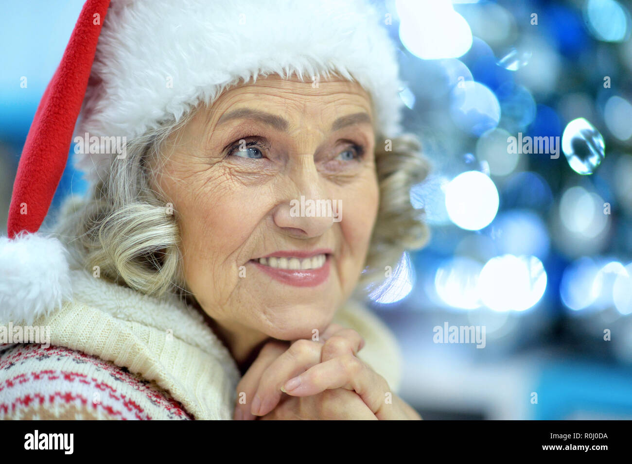Portrait of senior woman in Santa hat Stock Photo - Alamy