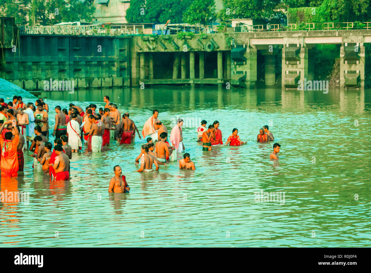 HARIDWAR, INDIA - JANUARY 14, 2016: Devotees taking holy dip at Har Ki Pauri on river Ganga on the first bath of Ardh Kumbh fair. People bathing Stock Photo