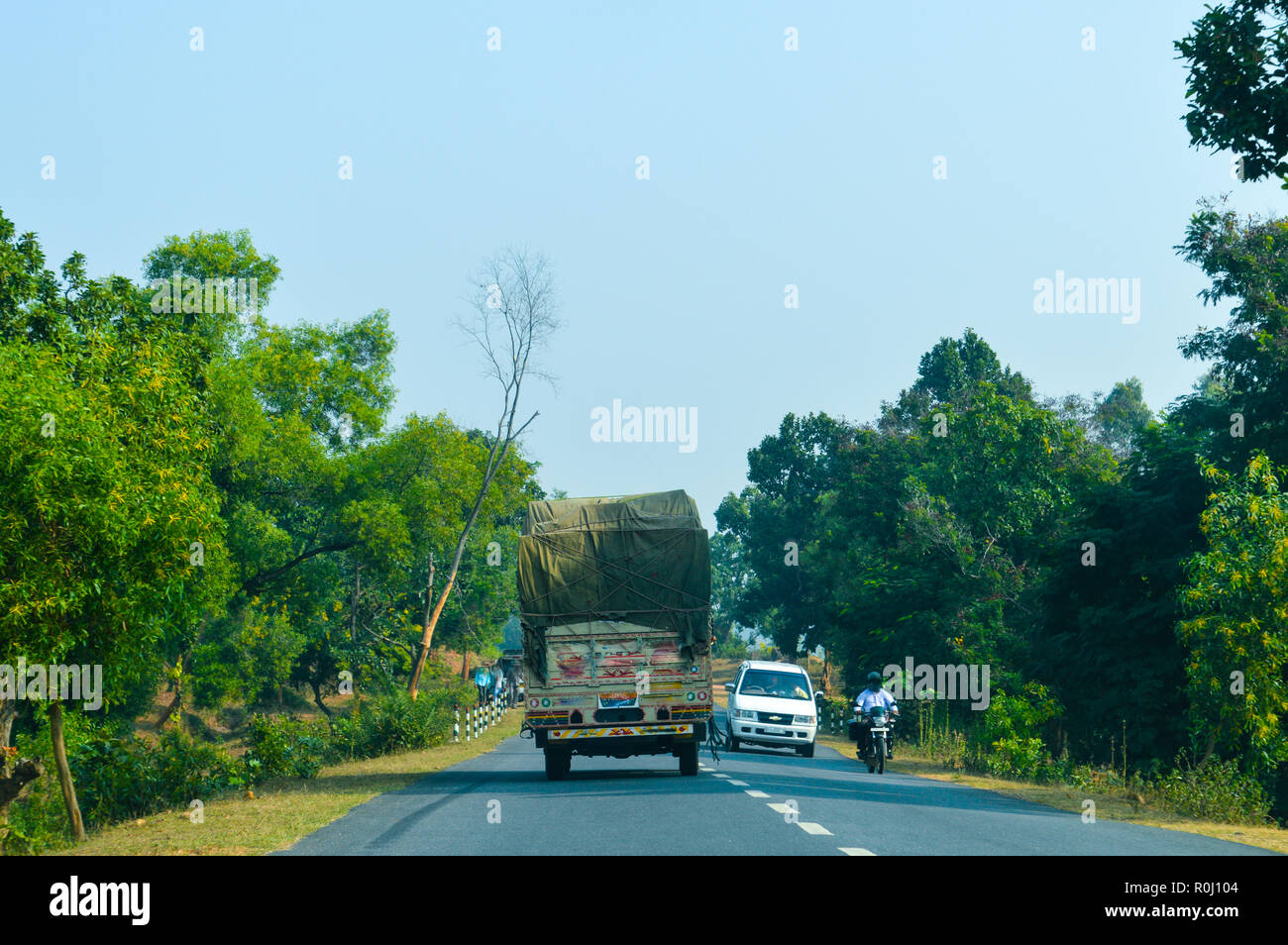 Semi Truck with Cargo Trailer Drives with container on highway, transportation concept. Truck is First in the Column of Heavy Vehicles. G T Road, Kolk Stock Photo