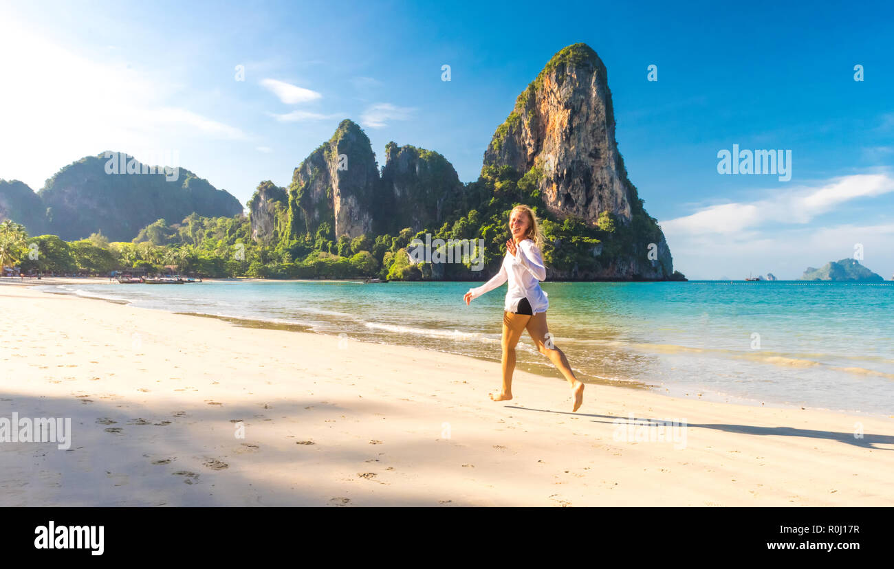 Woman running on Railay beach Krabi Thailand. Asia Stock Photo