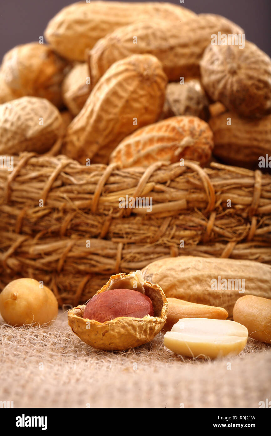 Peanuts in wicker basket and empty space for text Stock Photo