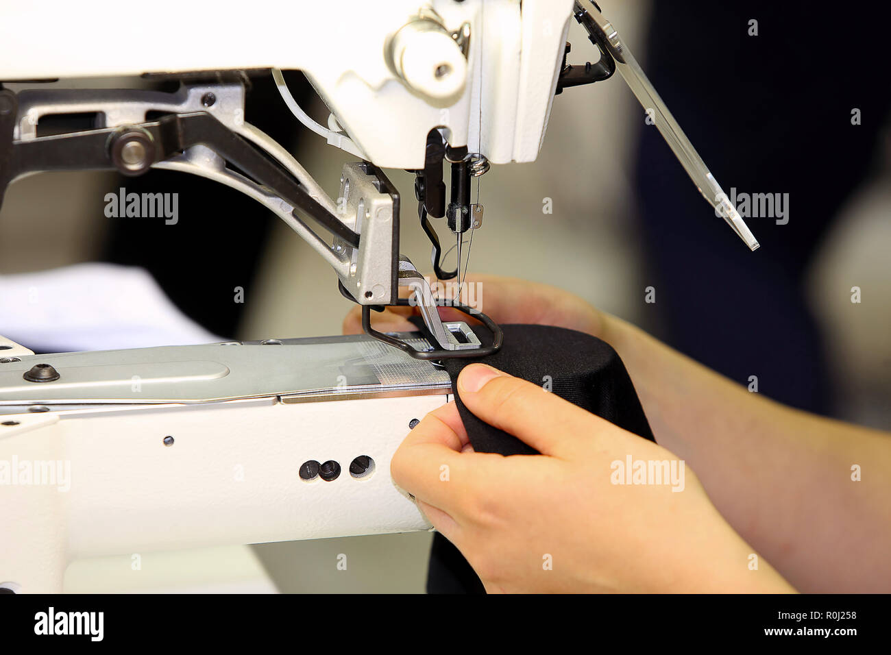 Tailor sews on the sewing machine Stock Photo