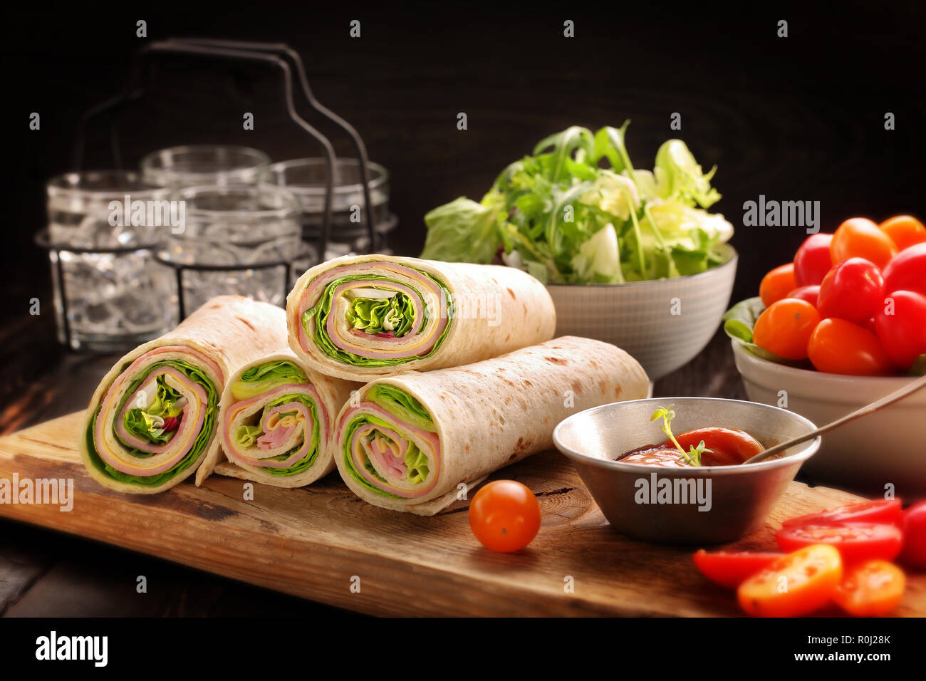 Tortilla wraps with with lettuce, ham and cheese sliced in half