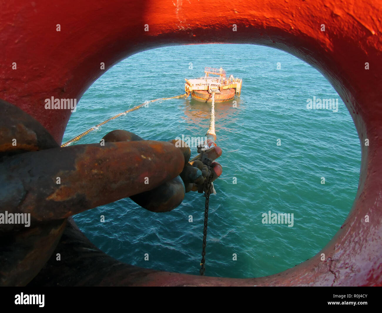 Offshore oil loading from single buoy mooring into oil tanker. Single buoy mooring serves as mooring point for tankers loading and offloading gas and  Stock Photo