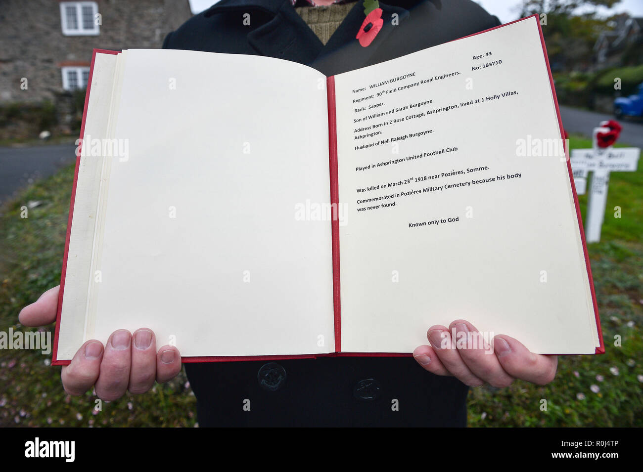 The Ashprington War Dead book, opened on the memorial page of William Burgoyne, who was born in the Devon village of Ashprington and killed in the Somme, 1918. The book is placed for members of the public to read and features details of men and women from the parish of Ashprington, Devon that served during the First World War. Stock Photo