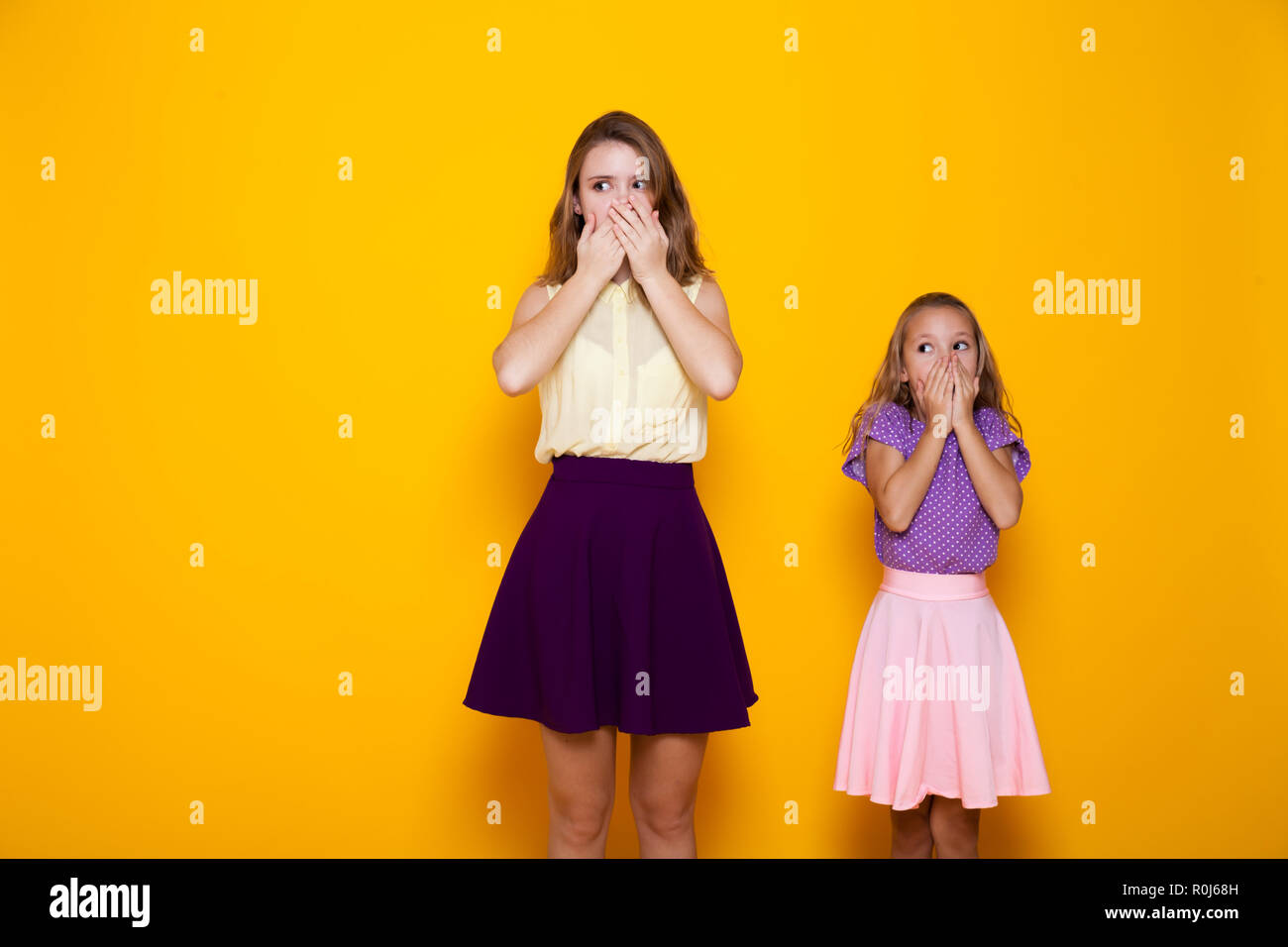 two beautiful girls close mouth silence and mystery Stock Photo