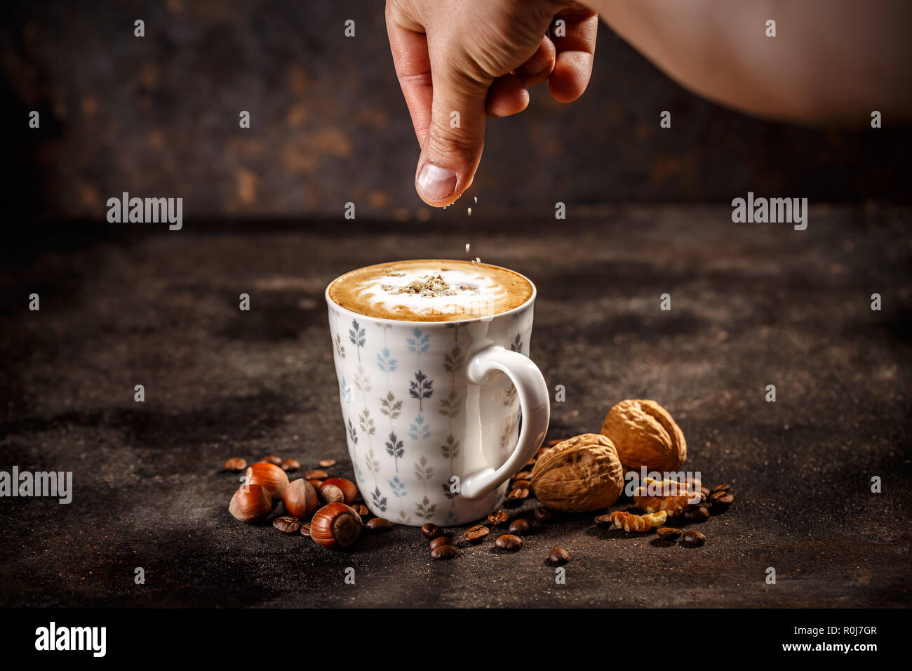 Hazelnut and walnut flavored coffee latte on vintage dark background Stock Photo
