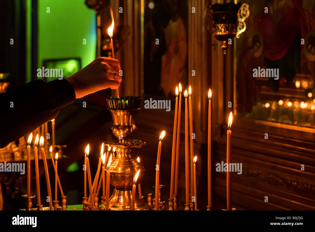 Woman hand lighting candles in a church Stock Photo Alamy
