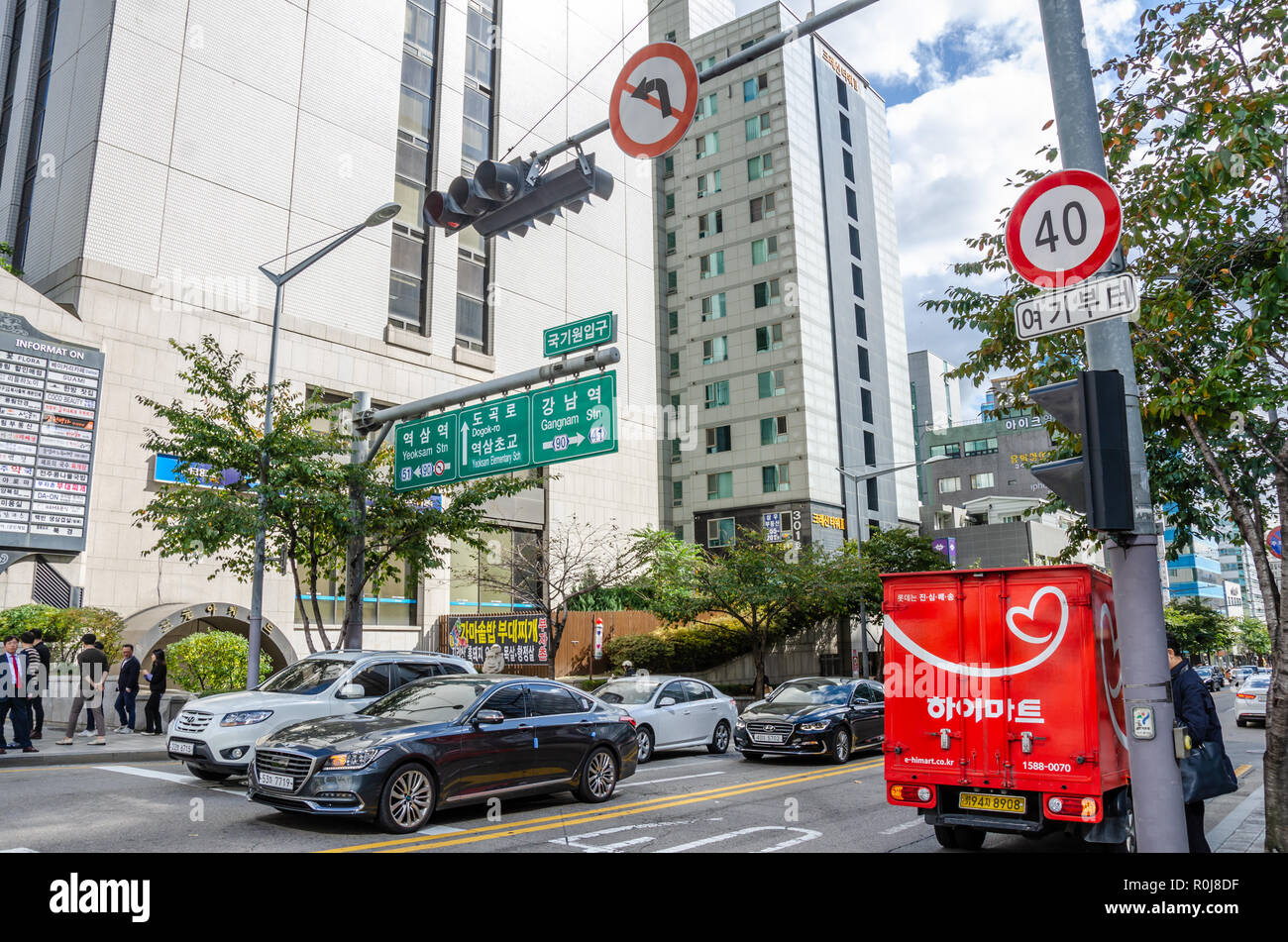 A busy road junction in Gangnam, Seoul, South Korea. Signs hanging overhead help drivers navigate. Stock Photo