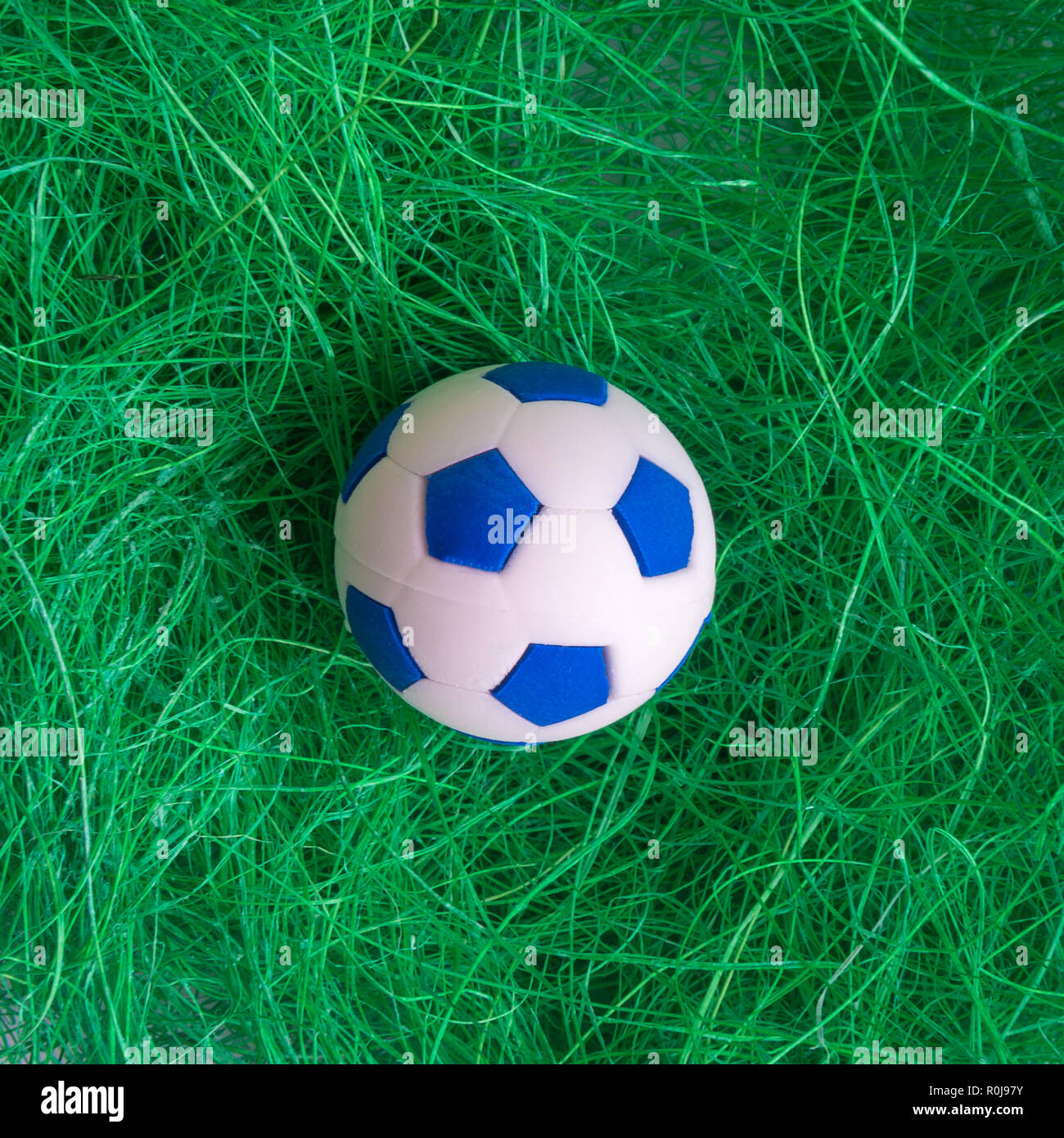 Soccer ball in grass minimal sport creative concept. Stock Photo