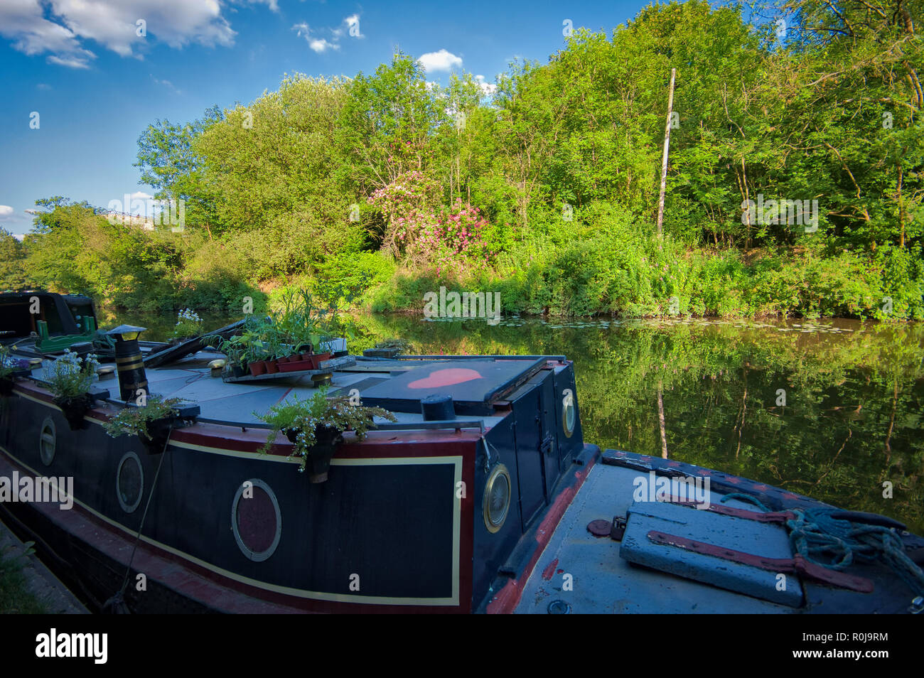 A navy blue boat with red heart in Harefield, on Grand Union Canal, United Kingdom Stock Photo