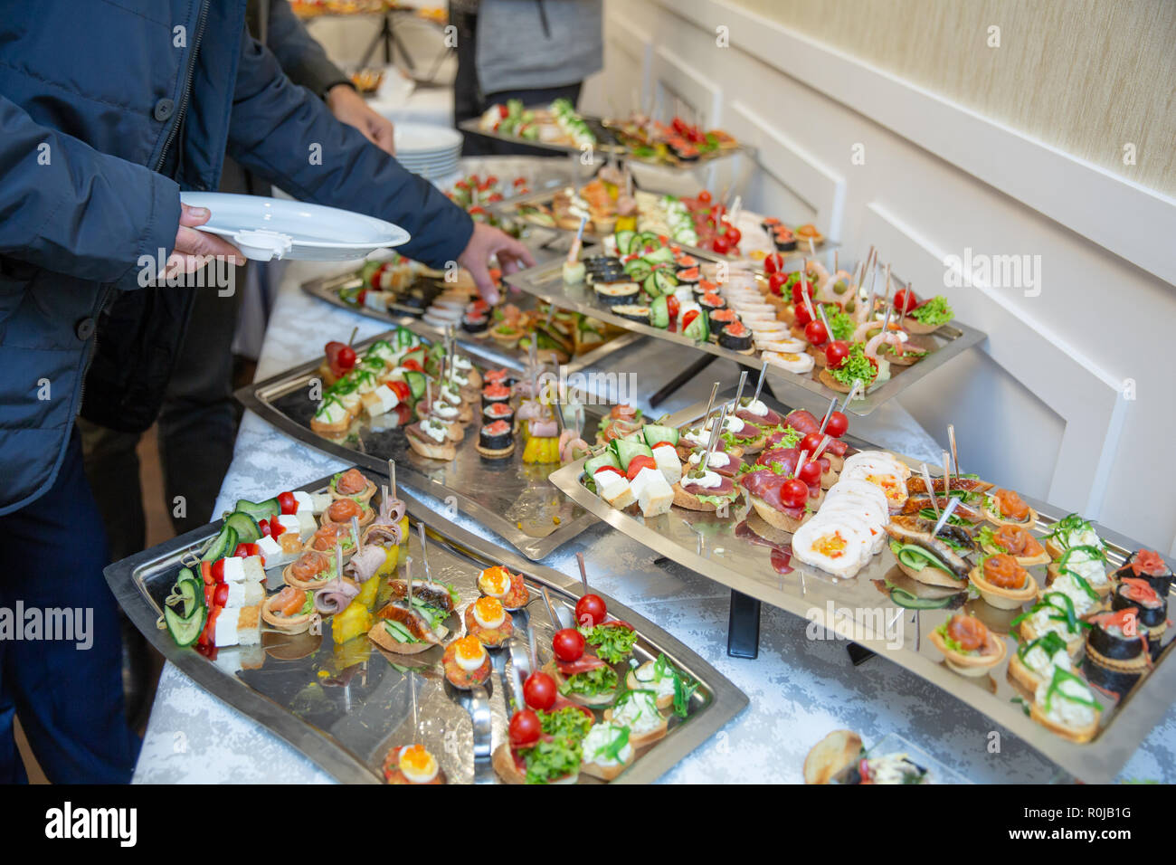 Catering table set service various snacks on a table at banquet. Set of ...