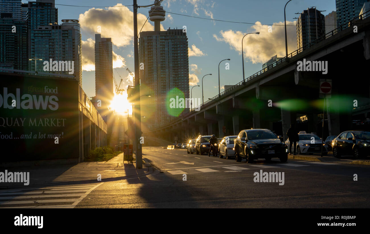 Highway 407 in downtown TO. The picture has been taken just before the golden hour when the sun is in its soft spot illuminating the city with gold. Stock Photo