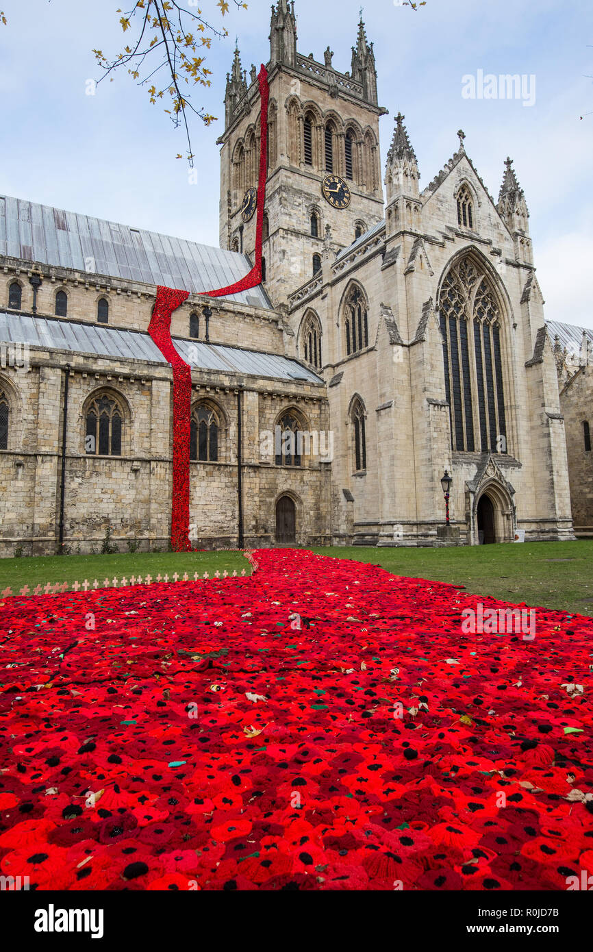 SELBY, NORTH YORKSHIRE, UK - NOVEMBER 4, 2018. The exterior of Selby Abbey decorated with a cascade of poppies to commemorate the centenary of WW1 Stock Photo
