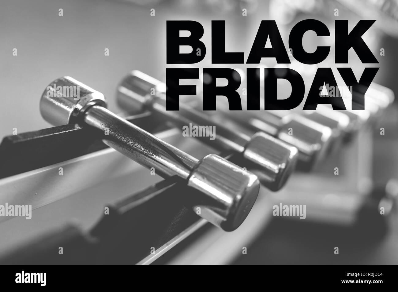 Black friday poster. Rows of dumbbells in the gym with high contrast light  Stock Photo - Alamy