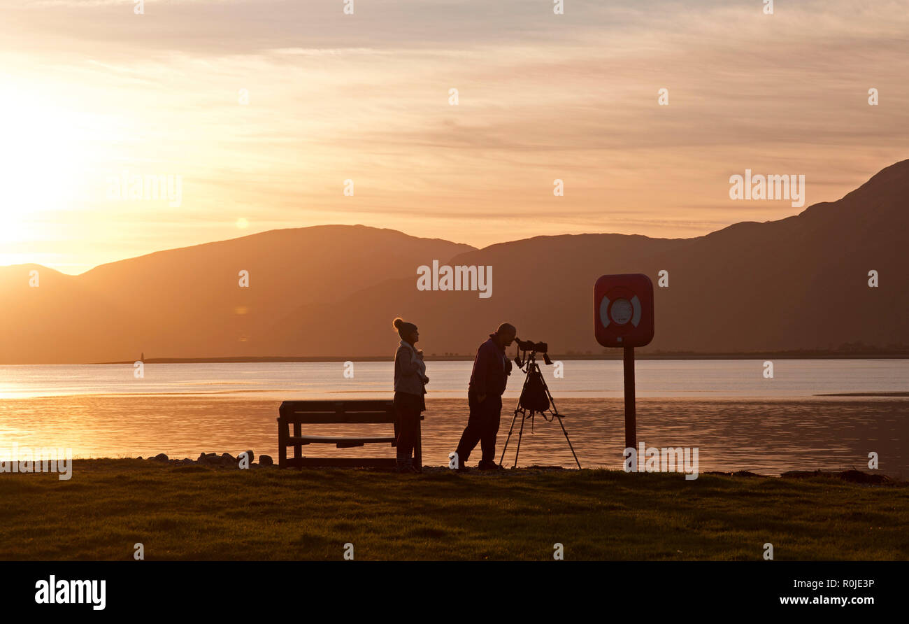 Silhouettes of people at sunset, Bunree, with Loch Linnhe in background, Lochaber, Scotland, UK Stock Photo