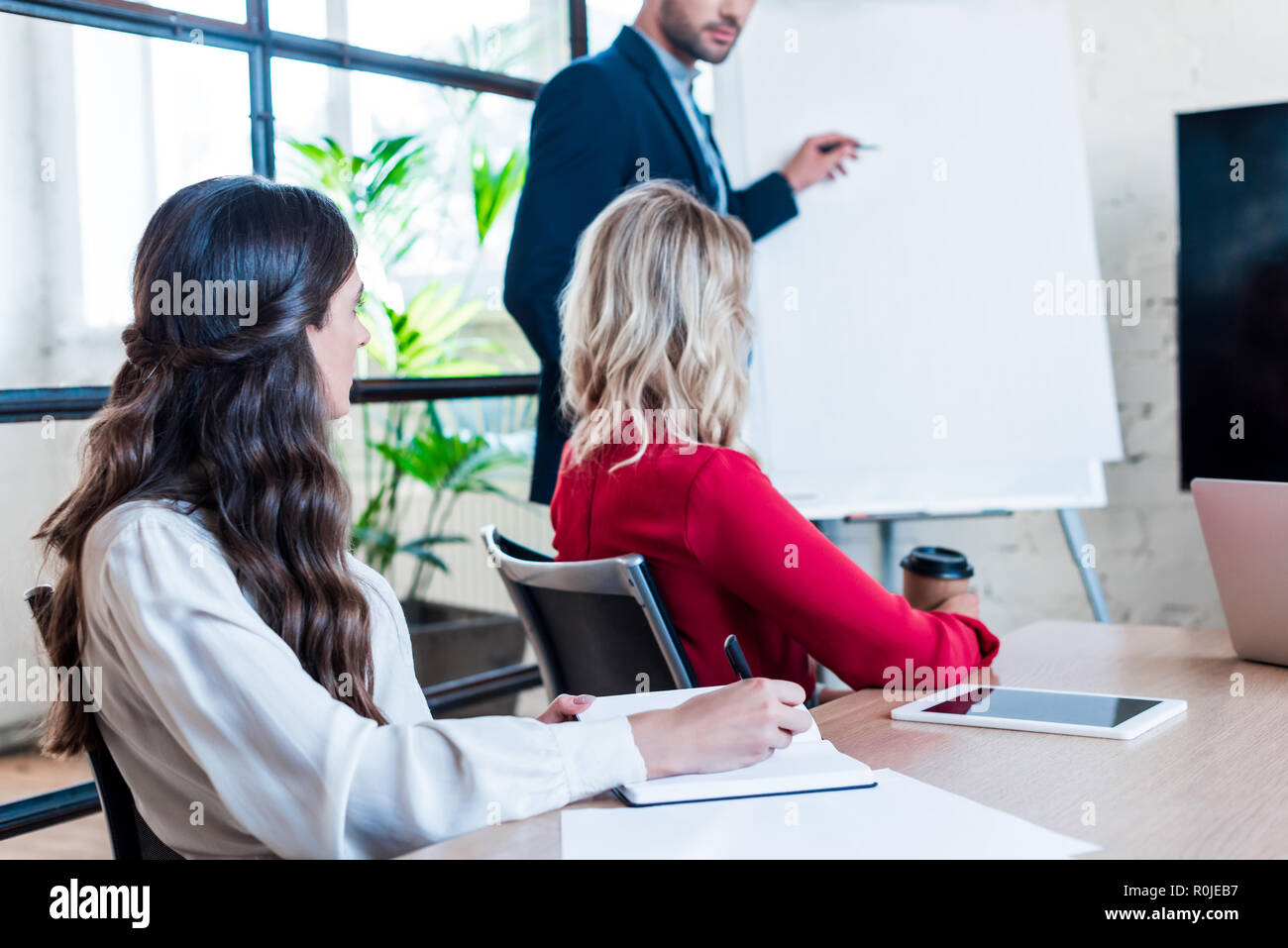 partial view of businessman and businesswomen having meeting in office ...