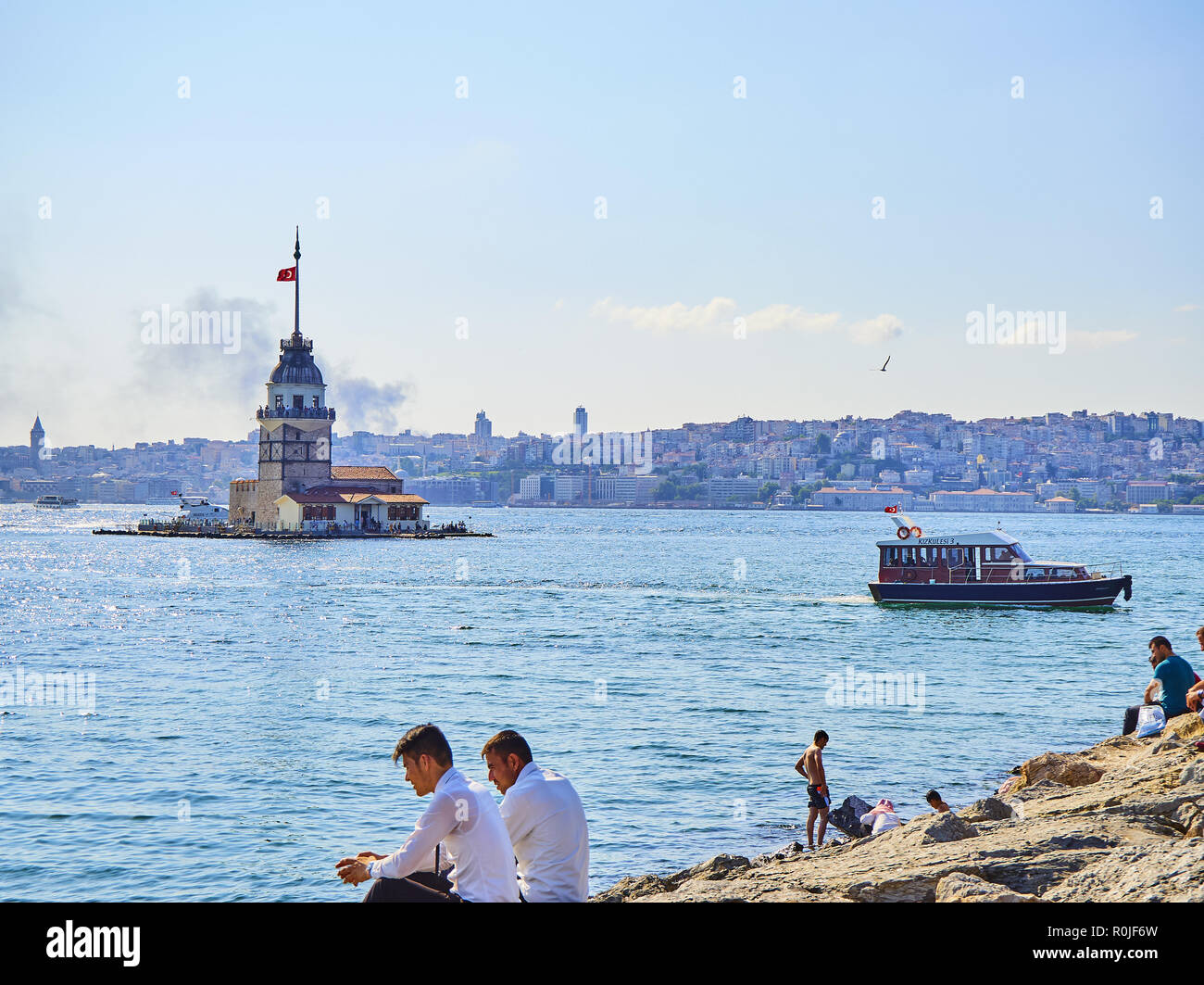 The Maiden's Tower at the Bosphorus, with the Karakoy neighborhood skyline in the background. Istanbul, Turkey. Stock Photo