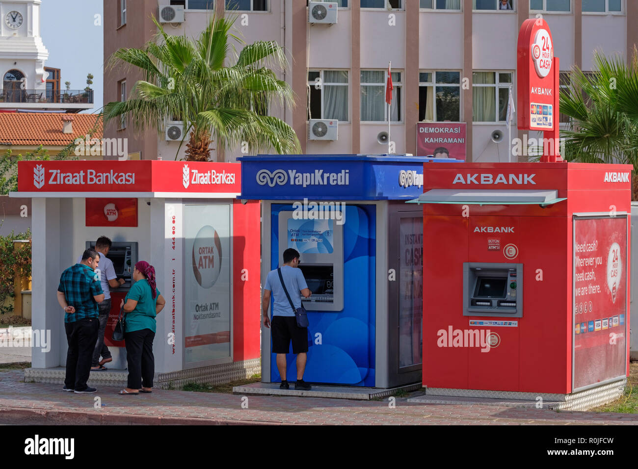 People using Ziraat Bankasi, YapiKredi and Akbank ATM machines in Kemer, Turkey Stock Photo