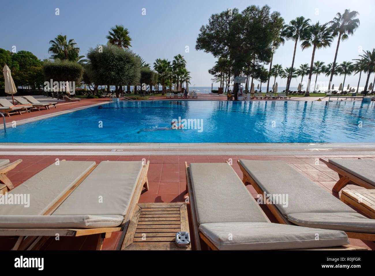 Man swimming on outdoor swimming pool at the Club Med Palmiye luxury all inclusive resort, Kemer, Antalya, Turkey Stock Photo