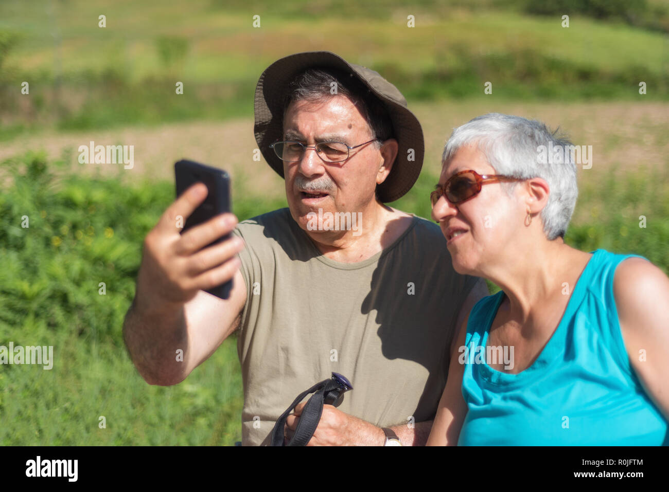 Senior couple on hike taking a selfie Stock Photo