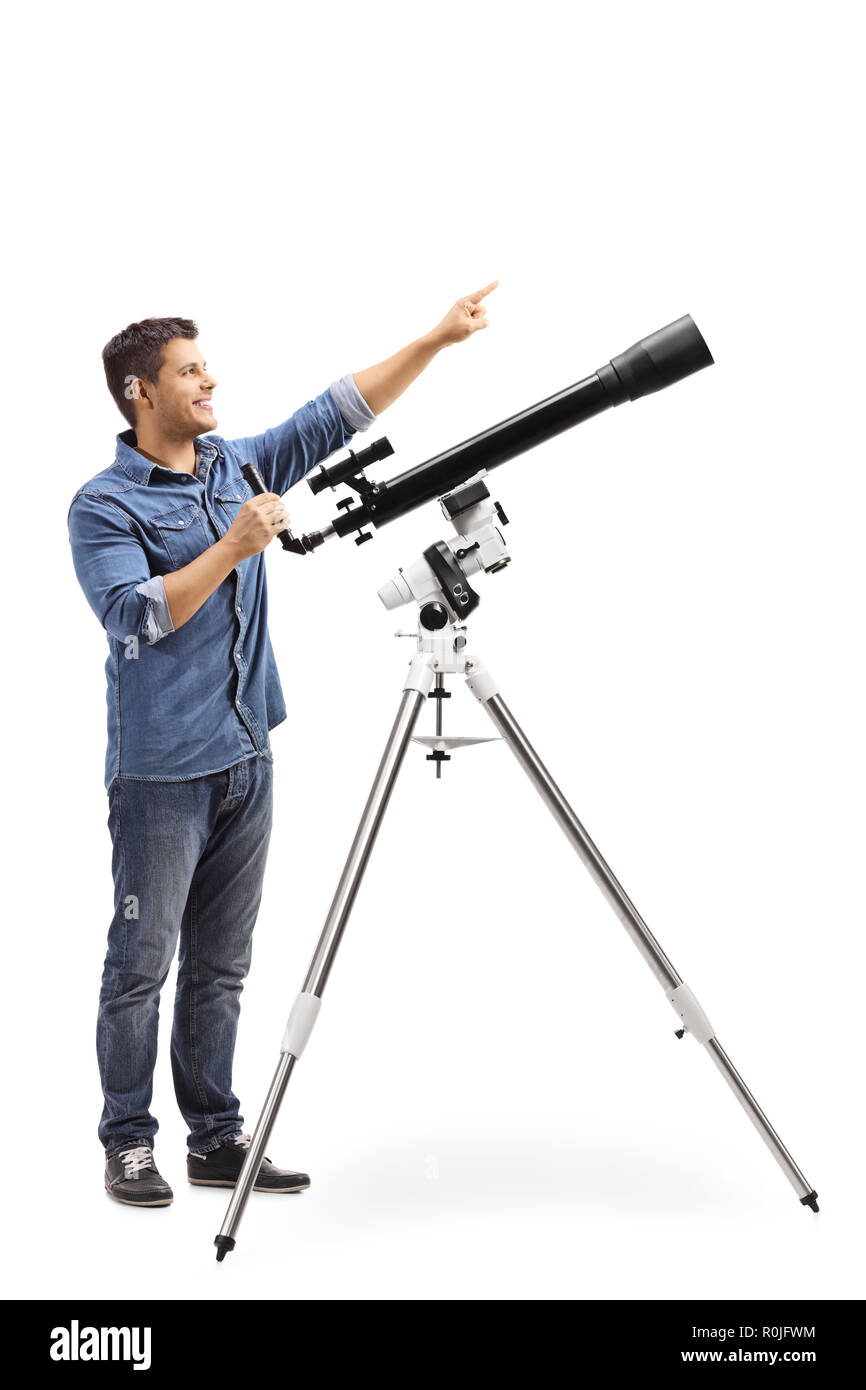 Full length shot a man standing next to a telescope and pointing up isolated on white background Stock Photo