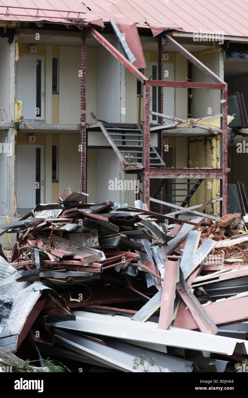 Scrap metal in front of partially demolished house Stock Photo - Alamy