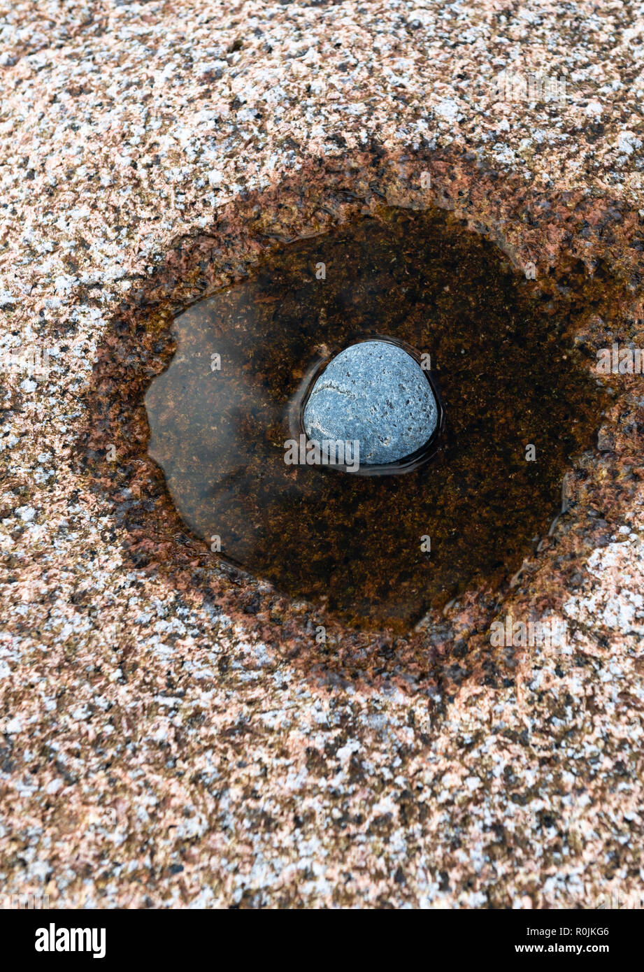 Square Of Rounded Rocks Hollow A round stone lies in a hollow of rose granite Stock Photo - Alamy