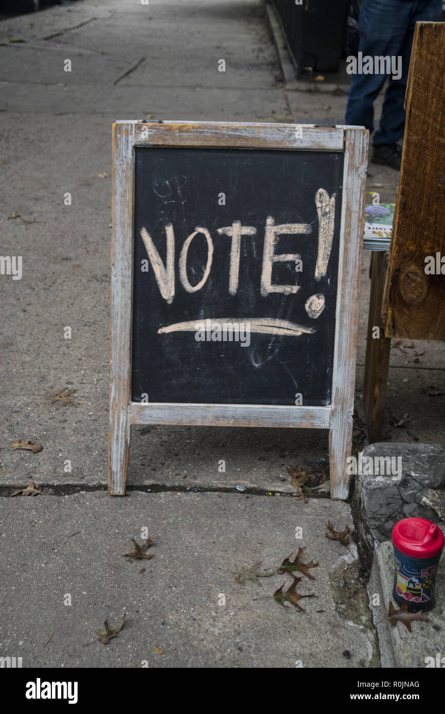 Sign outside a newspaper magazine shop reminds citizens to vote in elections. Park Slope, Brooklyn, New York. Stock Photo