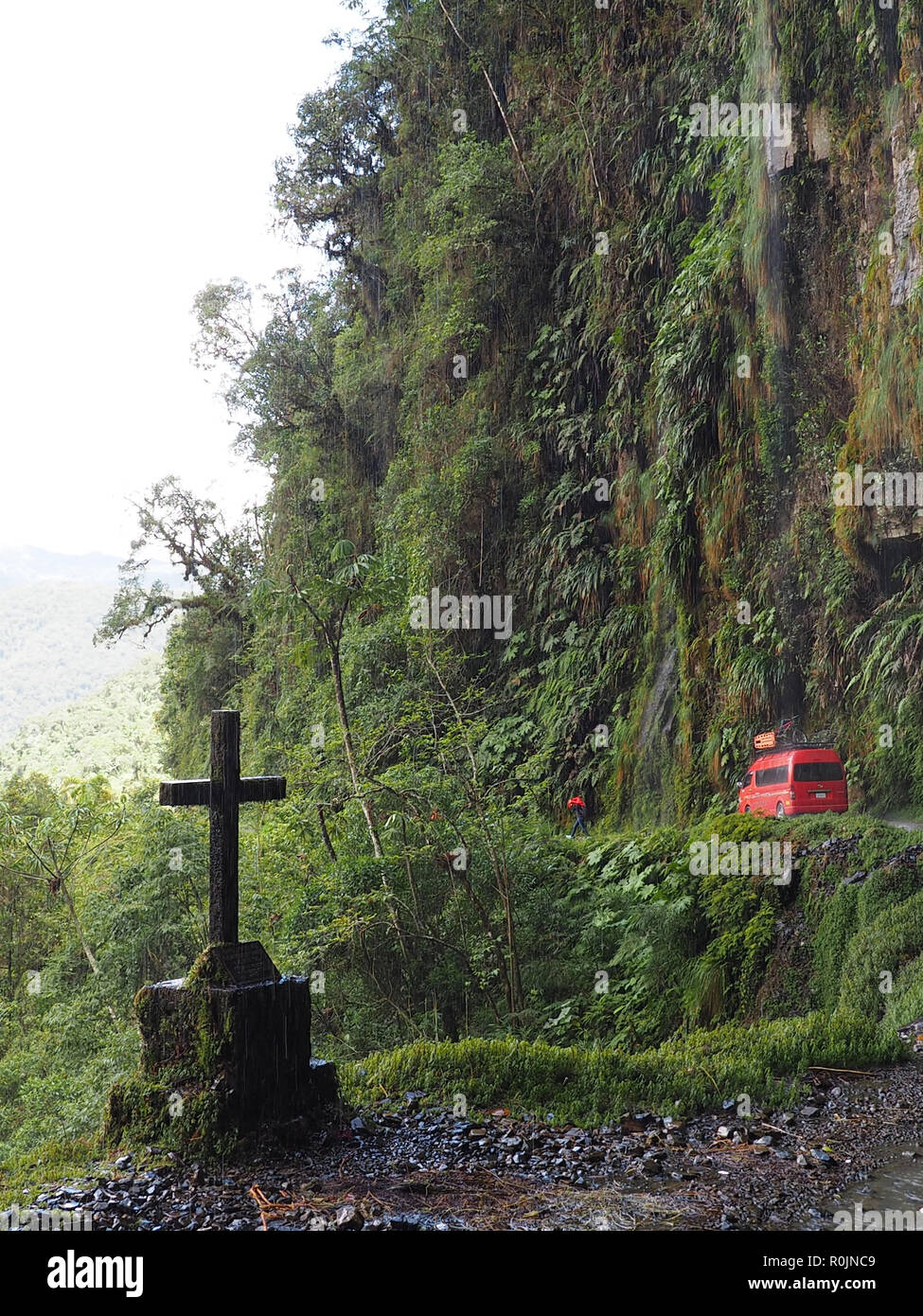 Red minibus and cross on death road, the worlds most dangerous road, on the way to the Yungas, La Paz, Bolivia, November 14, 2017 Stock Photo