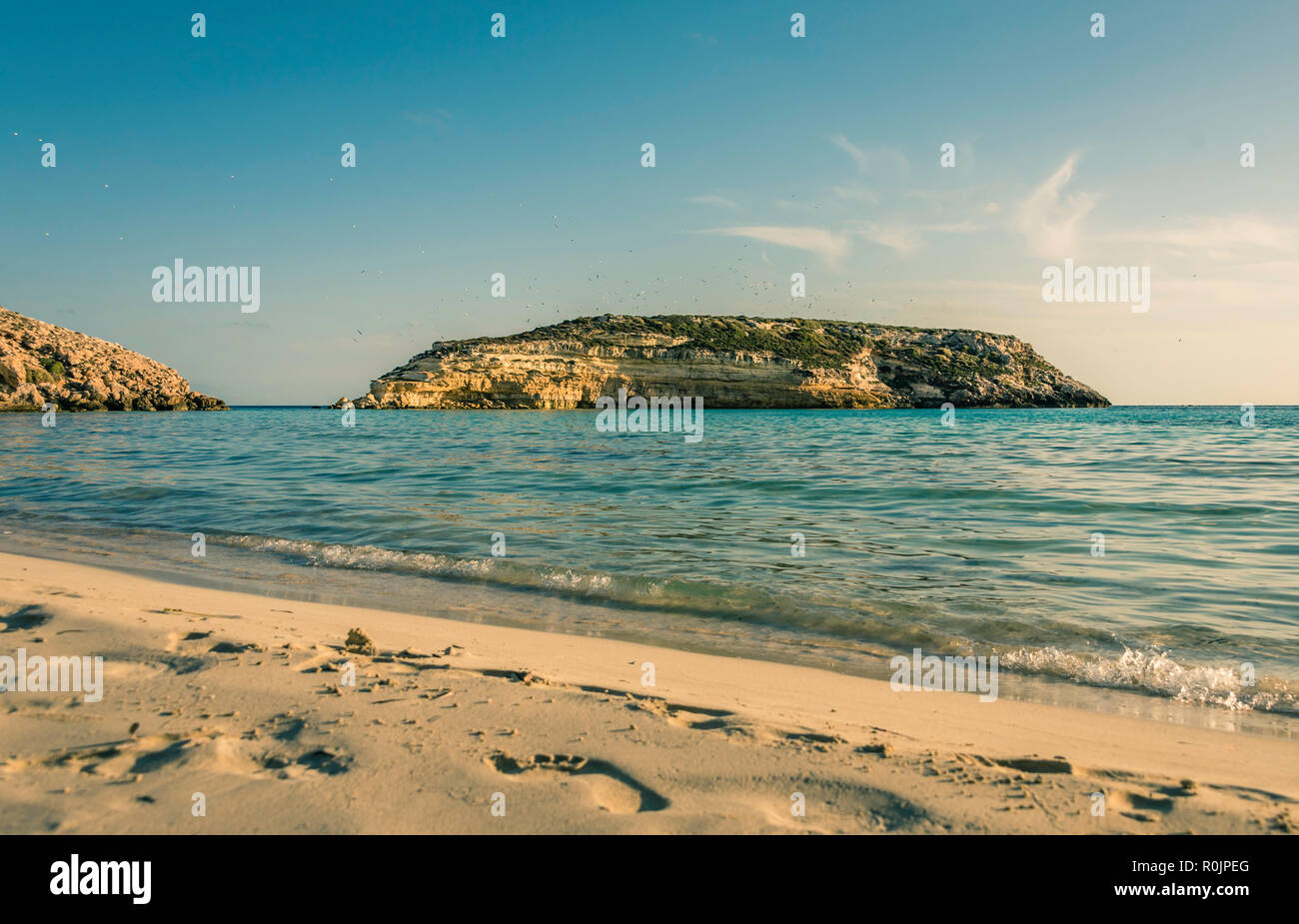 Crystal clear water at the Rabbit beach (Spiaggia dei Conigli) in the Pelagie IslandLampedusa. Sicily. Stock Photo