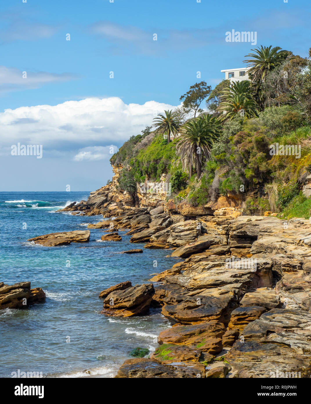 Rocky sandstone cliffs of Gordons Bay Pacific Ocean Sydney NSW Australia. Stock Photo