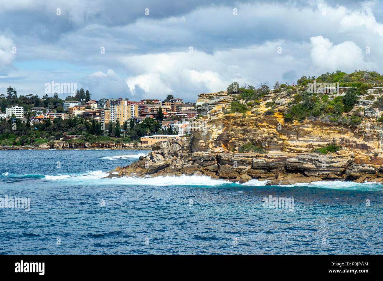Rocky sandstone cliffs of Gordons Bay Pacific Ocean Sydney NSW Australia. Stock Photo