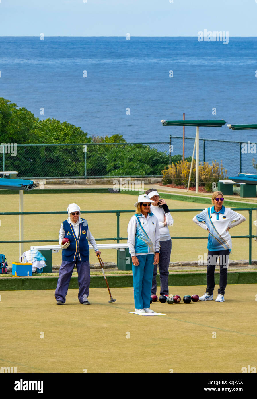 Four middle age to elderly women playing lawn bowls at Clovelly Bowling and Recreation Club Sydney NSW Australia. Stock Photo