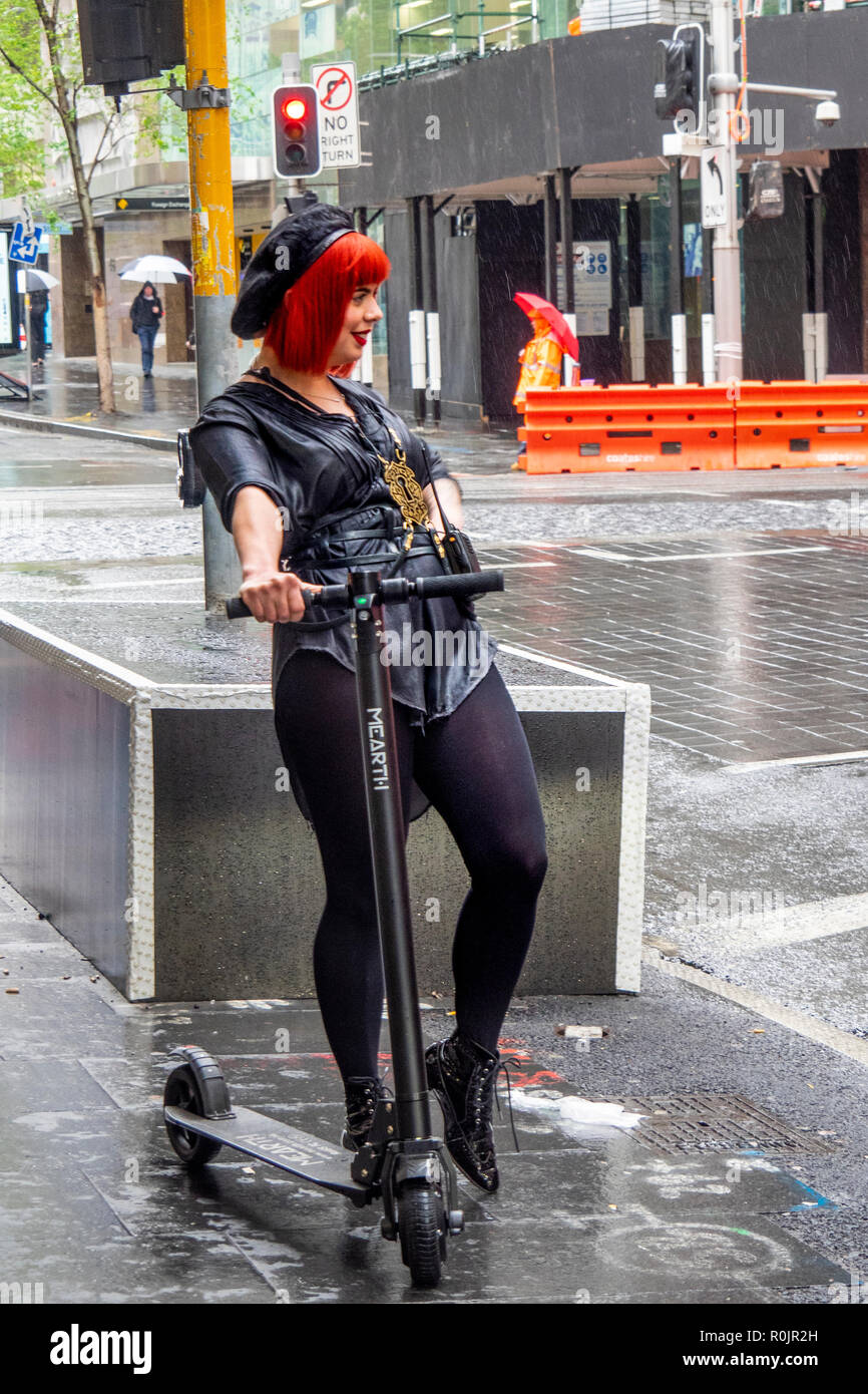 Flame haired concierge of QT Hotel on a kick scooter Sydney NSW Australia. Stock Photo