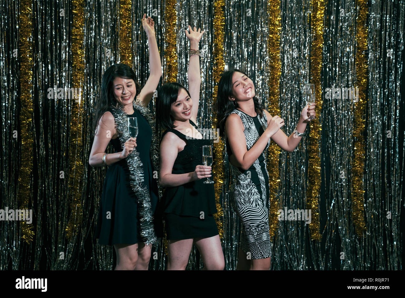 group of girl dancers dancing on the stage. young ladies holding wine having fun in nightclub at night. people nightlife party holidays celebration li Stock Photo